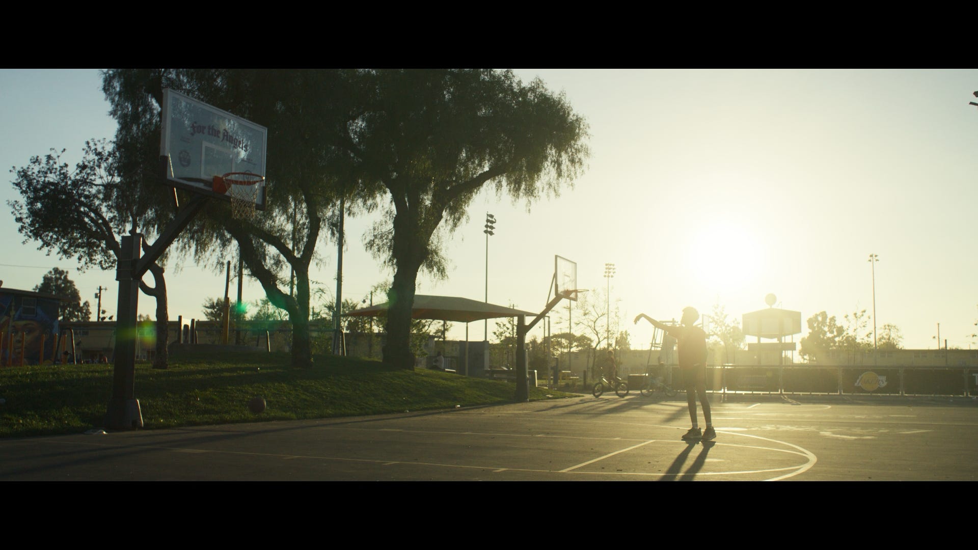 Film still — basketball court at golden hour